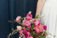 a stunning wedding bouquet of pink peonies and bougainvillea plus greenery and white fillers for a pink summer wedding