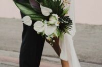 a stylish modern wedding bouquet of white anthurium, fronds and leaves is a cool and catchy idea