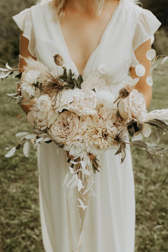 a subtle neutral wedding bouquet of roses, dahlias and peonies, lunaria, greenery and thistles is a lovely idea for a summer bride