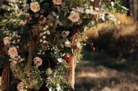 a super lush wedding arch done with blush roses, berries, greenery, green hydrangeas, branches and twigs, amaranthus is a statement idea for a fall wedding