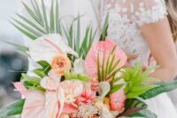 a tropical wedding bouquet of blush anthurium, peony roses and other blooms and greenery is a fantastic wedding solution