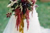 a unique fall wedding bouquet of deep purple callas, burgundy blooms, amaranthus and greenery and long mustard ribbons is wow