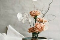 a unique ikebana wedding centerpiece of peachy carnations, twigs and lunaria is a cool and stylish idea for a wedding