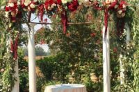 a wedding chuppah with greenery, white and burgundy blooms plus amaranthus is a refined vintage-inspired idea