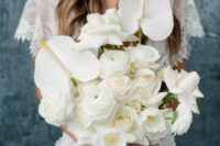 a white wedding bouquet of anthurium, roses and ranunculus is a stylish and lush solution for a modern bride