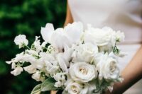 an all-white wedding bouquet of roses, snowdrops and sweet peas is a dreamy and delicate idea for a wedding