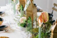 boho wedding centerpieces of ferns, anthuriums and Moroccan candle lanterns and green candles