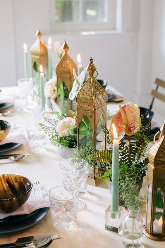 boho wedding centerpieces of ferns, anthuriums and Moroccan candle lanterns and green candles
