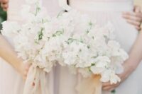 classy white wedding bouquets of sweet peas are great for a spring or summer wedding, they will fit many wedding styles
