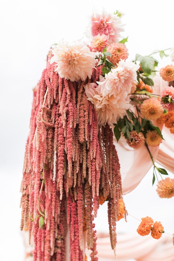 Decorate your wedding arch with blush dahlias, rust mums and amaranthus to make it delicate colored and textural looking