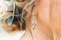 delicate yet chic crystal wedding earrings forming flowers and leaves are adorable for a chic and romantic bridal look