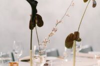 dramatic wedding centerpieces of deep purple callas and anthuriums in gold vases are amazing and super bold