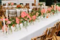 lovely multiple arrangements of pink roses and anthuriums and greenery and candles are amazing to make your space wow