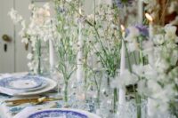 lovely wedding centerpieces of clear vases with periwinkle and white sweet peas are amazing for a relaxed summer wedding