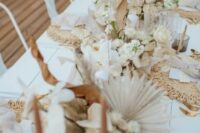 lush boho wedding centerpieces of white orchids, fronds, roses, leaves and lunaria look just fantastic and very inspiring