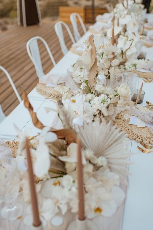 lush boho wedding centerpieces of white orchids, fronds, roses, leaves and lunaria look just fantastic and very inspiring