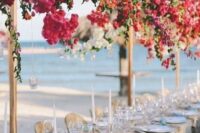 overhead floral installations of bougainvillea and white blooms plus greenery is a gorgeous idea for a Mediterranean wedding