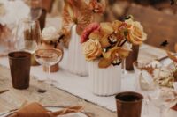 rust-colored wedding centerpieces of roses, dahlias, anthuriums and carnations for a modern boho wedding