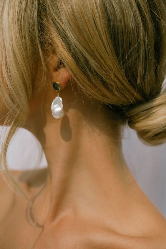 stylish wedding earrings with gold coins and a suspended baroque pearl are edgy and bold for a modern bride