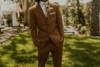 13 a brown pantsuit, a white shirt, a tan tie, black shoes and a dried flower boutonniere for a boho groom