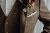 23 a brown tweed three-piece suit, a white button down, a burgundy velvet bow tie and a matching boutonniere