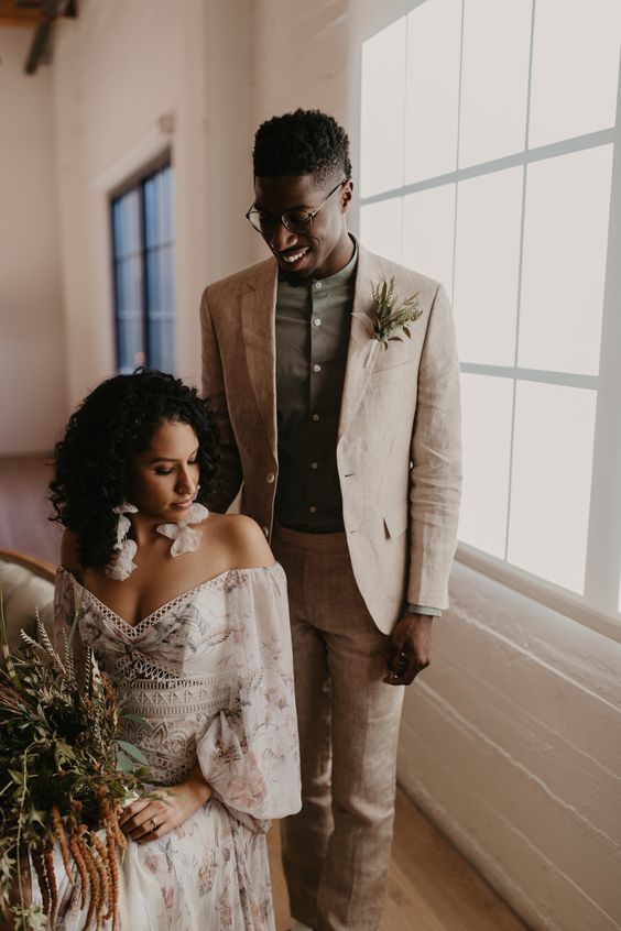 a tan linen pantsuit, an olive green shirt, a greenery boutonniere are a cool and comfortable combo for a tropical wedding