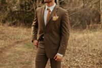 32 a refined fall groom’s look with a brown checked pantsuit, a white shirt, an orange tie and a dried flower boutonniere