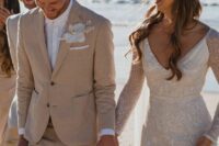 33 a tan pantsuit, a white shirt, a white orchid boutonniere are a great combo for a beach groom’s look
