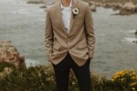 47 a relaxed groom’s outfit with a white shirt, a beige blazer, black trousers, grey shoes and a boutonniere is great
