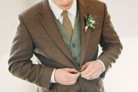 50 a modern groom’s look with a green waistcoat and trousers, a brown blazer, a white shirt and a beige tie