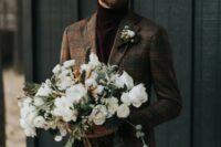 51 brown velvet pants and a matching turtleneck, a brown plaid blazer and a boutonniere for a casual winter groom’s look