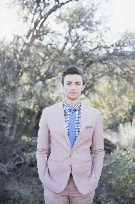a blush suit, a printed shirt and a blue polka dot tie is a whimsy groom's look for spring or summer