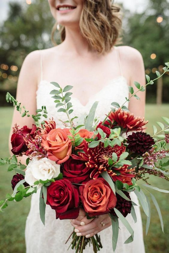 a bold fall wedding bouquet of peachy, white, red and burgundy roses, chrysanthemums, greenery is a fantastic idea