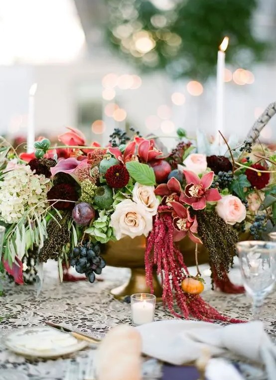 a bold fall wedding centerpiece of blush roses and peony roses, dahlias, mums, callas, amaranthus, greeneyr, grapes and hydrangeas