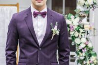 a bright groom’s look with a purple plaid suit, a white shirt, a purple bow tie and a blush boutonniere