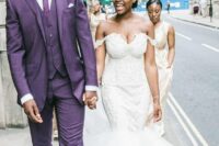 a bright purple groom’s suit, with a waistcoat, a tie and black shoes for a statement look at the wedding