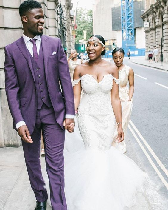 a bright purple groom's suit, with a waistcoat, a tie and black shoes for a statement look at the wedding