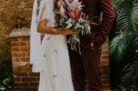 a burgundy suit, a black velvet bow tie, amber-colored shoes for a tropical groom’s look with a twist
