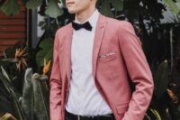 a chic groom’s look with a white shirt, a pink blazer, a black bow tie and black pants is a cool idea for a modern wedding