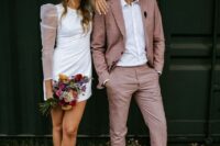 a chic modern groom’s look with a mauve pantsuit, white sneakers, a white shirt are a cool combo with an unusual touch of color
