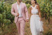 a dusty pink pantsuit, a white shirt, white sneakers are a cool combo for a spring or summer groom’s look