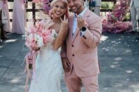 a dusty pink pantsuit with an oversized blazer, a white shirt, white sneakers are a lovely combo for a modern wedding with lots of pink