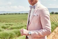 a light pik groom’s suit with a white shirt, a floral bow tie and a handkerchief are a great look for a spring wedding