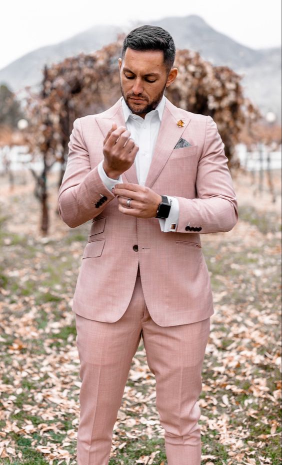 a lovely groom's look with a light pink pantsuit, a white shirt and a stylish watch is a cool idea for spring