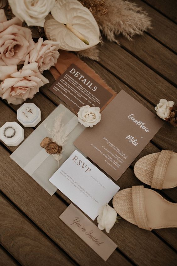 a lovely wedding invitation suite with a brown, taupe, white card and a vellum envelope is cool