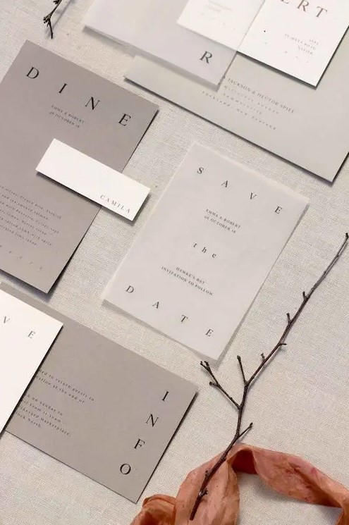 a minimalist shades of grey wedding invitation suite with sheer parts and black letters is a lovely idea for a minimal wedding in greys