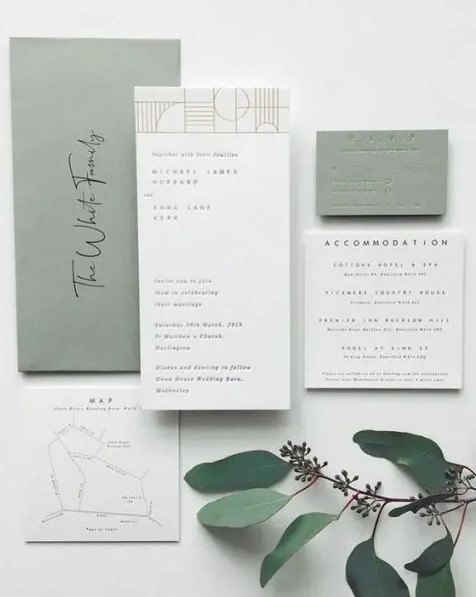 a modern sage green wedding invitation suite with white elements and stylish letters plus letterpressing