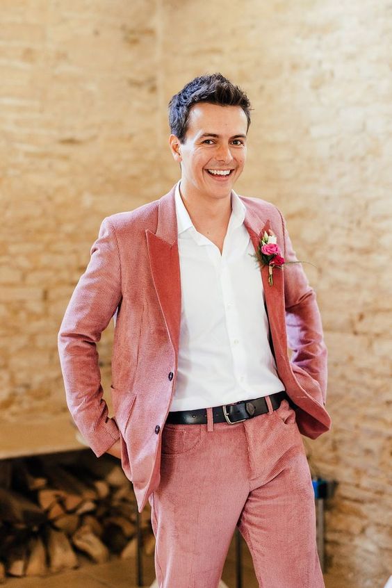 a pink corduroy pantsuit, a white shirt, a black belt and a colorful boutonniere are a lovely idea for a bright wedding