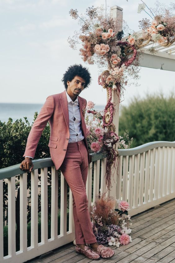 a pink pantsuit, a white shirt and pink loafers are a lovely outfit for a modern wedding with touches of pink and mauve
