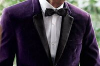 a purple velvet tux with black lapels is a refined and chic groom’s outfit idea